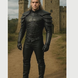 May include: A black leather armour set featuring a chest piece with layered shoulder pauldrons, long sleeves with integrated gauntlets, a buckled waist belt, matching trousers, and tall boots. The armour is detailed with small metal studs throughout.