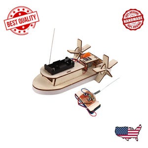 May include: A light brown wooden model boat with propellers, a battery compartment, and a remote control. The model is designed for assembly. The image includes the text "BEST QUALITY" and "100% ORIGINAL HANDMADE".