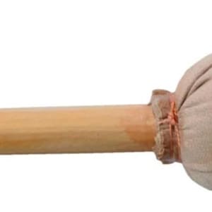 May include: A percussion mallet featuring a light brown wooden shaft and a rounded, beige head. The head is made of a soft, padded material, attached to the shaft with a reddish-brown binding. This mallet is designed for use with percussion instruments.