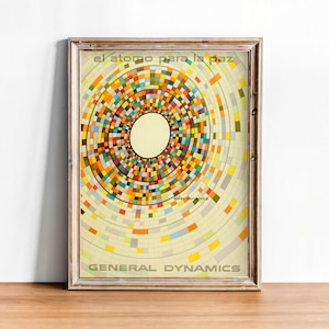 May include: Framed vintage poster with a colorful abstract design of concentric circles in shades of yellow, orange, blue, and green. The text "el atomo para la paz" is at the top, and "GENERAL DYNAMICS" is at the bottom.