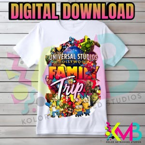 May include: White t-shirt featuring a colorful graphic design with the text "UNIVERSAL STUDIOS HOLLYWOOD FAMILY TRIP." The design includes various cartoon characters and the words "DIGITAL DOWNLOAD" at the top.