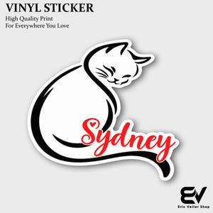 May include: A vinyl sticker featuring a black line art illustration of a sitting cat with its head turned. The name Sydney is written in red cursive script across the cat's body. The text VINYL STICKER, High Quality Print, For Everywhere You Love is visible.