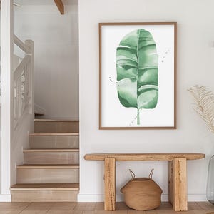 Watercolor banana leaf art print with lush green tones, perfect for tropical and botanical wall decor. Minimalist design captures nature-inspired style, adding a refreshing vibe to modern, bohemian, or office spaces. Unframed, ready to be styled