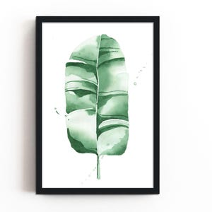 Watercolor banana leaf art print with lush green tones, perfect for tropical and botanical wall decor. Minimalist design captures nature-inspired style, adding a refreshing vibe to modern, bohemian, or office spaces. Unframed, ready to be styled