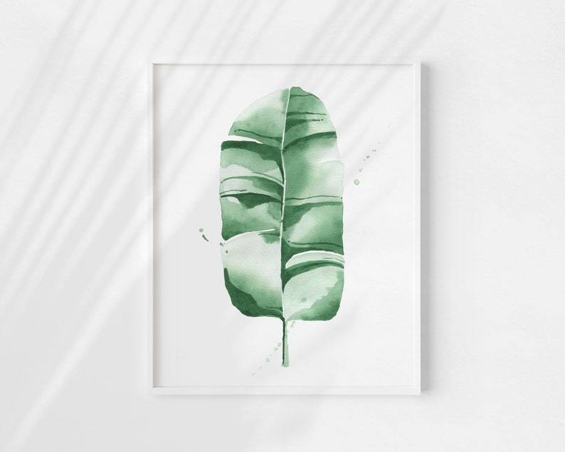 Watercolor banana leaf art print with lush green tones, perfect for tropical and botanical wall decor. Minimalist design captures nature-inspired style, adding a refreshing vibe to modern, bohemian, or office spaces. Unframed, ready to be styled