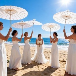 May include: A bride in a lace wedding dress stands on a sandy beach, surrounded by bridesmaids in white dresses. Each bridesmaid holds a white parasol. The bright sun shines over the ocean in the background.