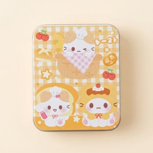 May include: Rectangular tin with a yellow gingham pattern and cartoon illustrations of cats dressed as baked goods. The tin features images of a cat in a bread bowl, a cat on toast, and a cat in a pastry.