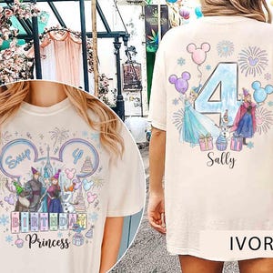 May include: An ivory t-shirt featuring a graphic print of characters from Frozen. The front displays the text 'Sally', 'BIRTHDAY', and 'Princess' with a castle and balloons. The back shows a large number 4, fireworks, and characters.