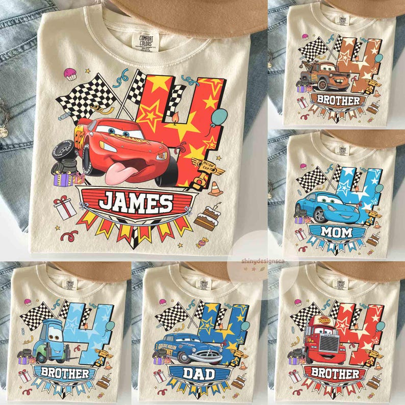 May include: Cream-colored t-shirts with colorful car-themed graphics. One shirt features a red race car with the name "JAMES". Other shirts have car graphics with the words "BROTHER", "MOM", and "DAD".