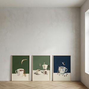 May include: Three framed art prints with coffee-themed illustrations. One shows a person diving into a coffee cup, another depicts a coffee maker, and the third has a person diving into a coffee cup. Each print has a green or blue background.