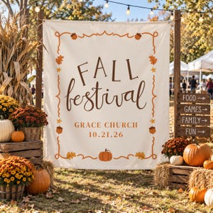 May include: A cream-colored fabric banner featuring the brown text FALL festival, GRACE CHURCH, and 10.21.26. The banner is framed by a decorative border of orange acorns and leaves, with a small orange pumpkin centered at the bottom edge.