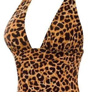May include: A sleeveless halter top featuring a brown and black leopard print pattern. The garment has a deep V-neckline and a solid black strap that wraps around the neck, providing a secure fit for this fitted, waist-length piece of clothing.