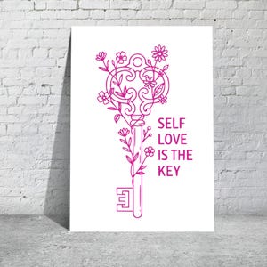 May include: A white poster with a pink line drawing of a key adorned with flowers and leaves. The text "SELF LOVE IS THE KEY" is printed in pink on the right side of the key. The poster is leaning against a white brick wall.