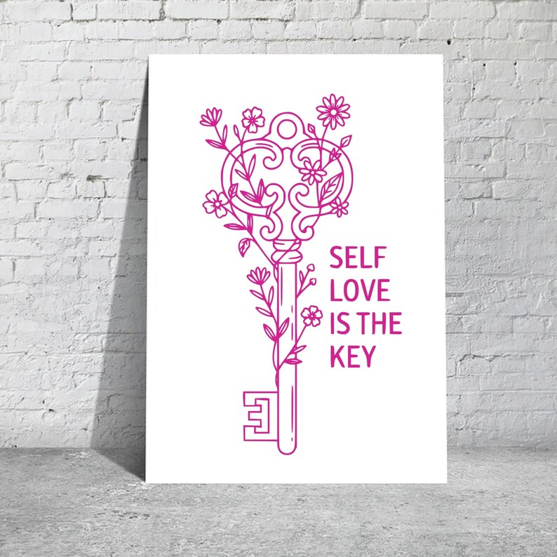 May include: A white poster with a pink line drawing of a key adorned with flowers and leaves. The text "SELF LOVE IS THE KEY" is printed in pink on the right side of the key. The poster is leaning against a white brick wall.