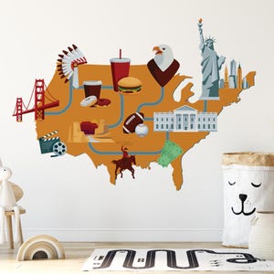 May include: A wall decal featuring a stylized map of the United States in shades of orange and brown. Iconic American symbols like the Statue of Liberty, a hamburger, and a football are depicted on the map.