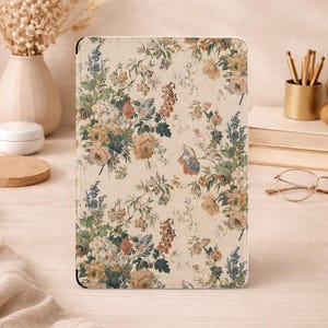 May include: A rectangular tablet case featuring a cream-colored background with a repeating floral pattern. The design includes clusters of muted yellow, soft pink, and dusty blue flowers with green foliage, covering the entire front surface.