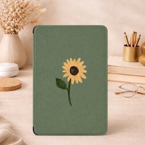 May include: A rectangular e-reader case in a solid sage green color featuring a centered illustration of a single yellow sunflower with a dark brown center and a green leaf on its stem. The case has a smooth, matte texture and rounded corners.