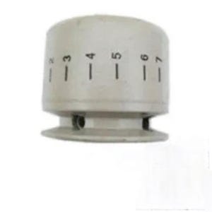 May include: A cylindrical off-white control knob featuring a series of black vertical hash marks and the printed numbers 2, 3, 4, 5, 6, and 7 arranged horizontally across the upper surface. The knob has a flared base and a recessed lower section.
