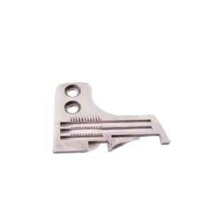 May include: A silver-colored metal sewing machine feed dog component featuring two circular mounting holes on the left side and three parallel horizontal slots containing small, fine metal teeth designed for fabric movement.