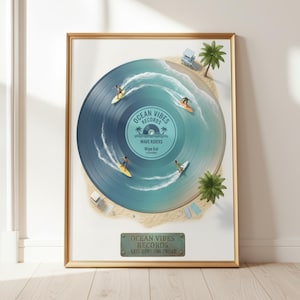 May include: Framed art print featuring a blue vinyl record design with surfers riding waves. The record label reads "Ocean Vibes Records, Wave Riders, Wipe Out." Palm trees and a beach scene surround the record. The print is in a gold frame.