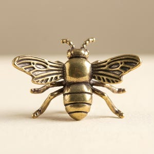 May include: A set of three ceramic mugs with a speckled, matte finish. The mugs are in shades of cream, light gray, and dark gray. Each mug has a simple, minimalist design, perfect for coffee or tea.