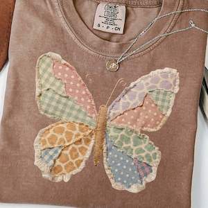 May include: A handmade wooden sign with the text "Welcome" in a playful font. The sign is painted white with a distressed finish, and features a decorative floral design in shades of pink and green. It measures approximately 12 inches wide.