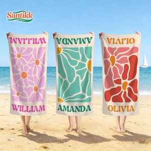 May include: Three rectangular beach towels featuring large floral patterns and personalised names. The first towel is light pink with orange centres, the second is teal with yellow centres, and the third is red and pink with orange centres.
