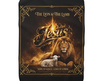 May include: A black rectangular fleece blanket featuring a central golden illustration of a lion and a lamb. The text reads THE LION & THE LAMB, JESUS, and KING OF KINGS - LORD OF LORDS. The design is framed by an ornate gold border with corner flourishes.