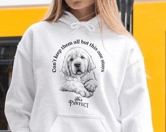 May include: A white hooded sweatshirt featuring a black and white graphic of a golden retriever puppy. The text reads, "Can't keep them all but this one stays" arched above the puppy and "He's PAWFECT" printed below the puppy illustration.