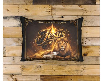 May include: A rectangular throw pillow featuring a dark background with a golden lion and a white lamb resting together. The text reads THE LION & THE LAMB, JESUS, and KING OF KINGS LORD OF LORDS in elegant gold script, surrounded by ornate golden borders.