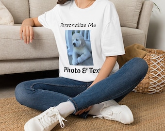 May include: A white short-sleeved t-shirt featuring a central rectangular graphic of a light-colored puppy. The text "Personalize Me" is printed in black above the image, and the text "Photo & Text" is printed in black below the image.
