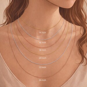 May include: A selection of delicate chain necklaces in gold, silver, and rose gold, displayed on a person's neck. The necklaces vary in length, with labels indicating sizes from 14 inches to 24 inches.