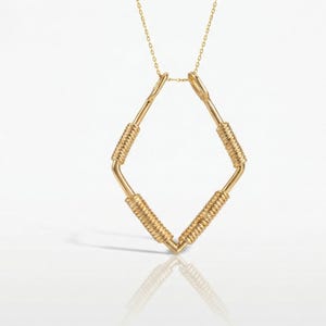 May include: A gold-colored necklace with a diamond-shaped pendant. The pendant is made of straight bars with coiled wire wrapped around the center of each bar. The necklace chain is delicate and gold-colored.