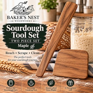 May include: A two-piece sourdough tool set made of maple wood, featuring a long, narrow spatula and a rectangular scraper. The text on the packaging reads Baker's Nest Woodworks, Sourdough Tool Set, Two Piece Set, Maple, Reach, Scrape, Clean.