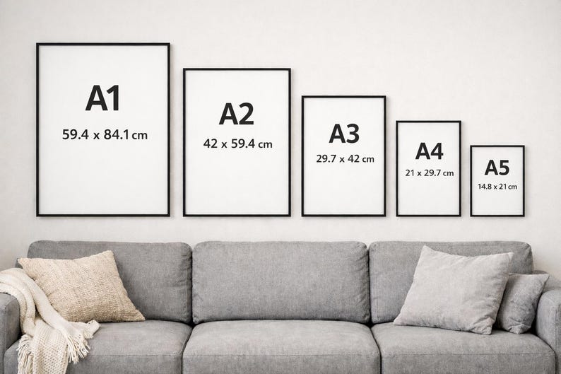 May include: Five framed art prints of varying sizes (A1, A2, A3, A4, A5) are displayed on a white wall above a gray sofa. The prints have black frames and white backgrounds with the size labeled in centimeters.