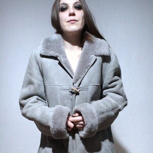 oversized sheepskin jacket with grey shearling interior and wooden buttons