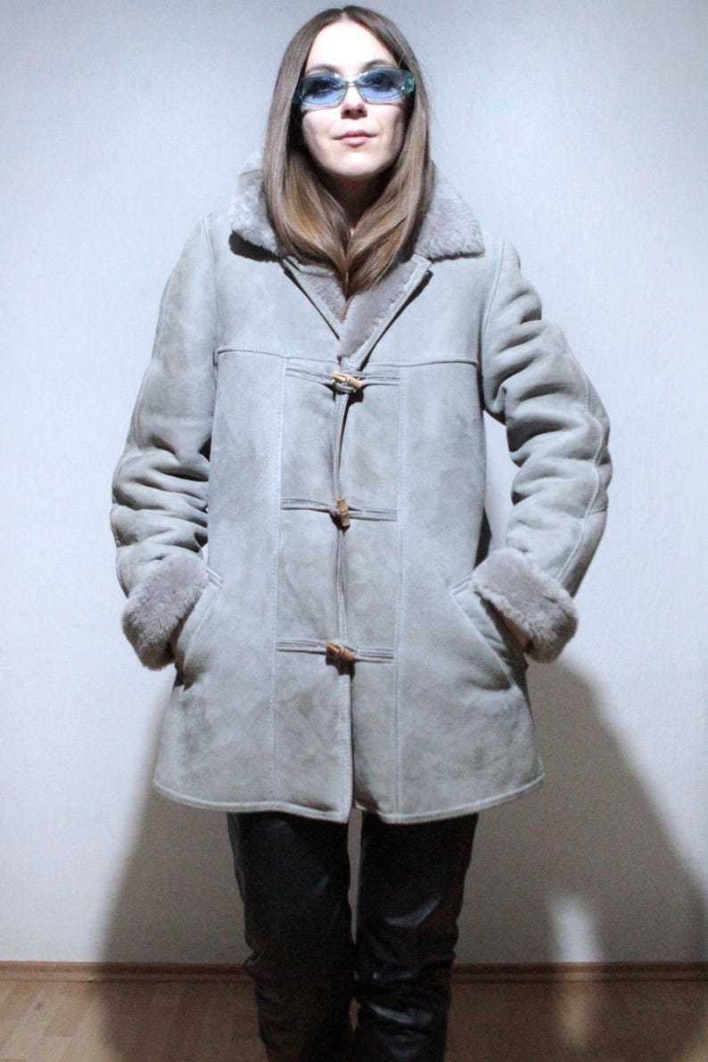 oversized sheepskin jacket with grey shearling interior and wooden buttons
