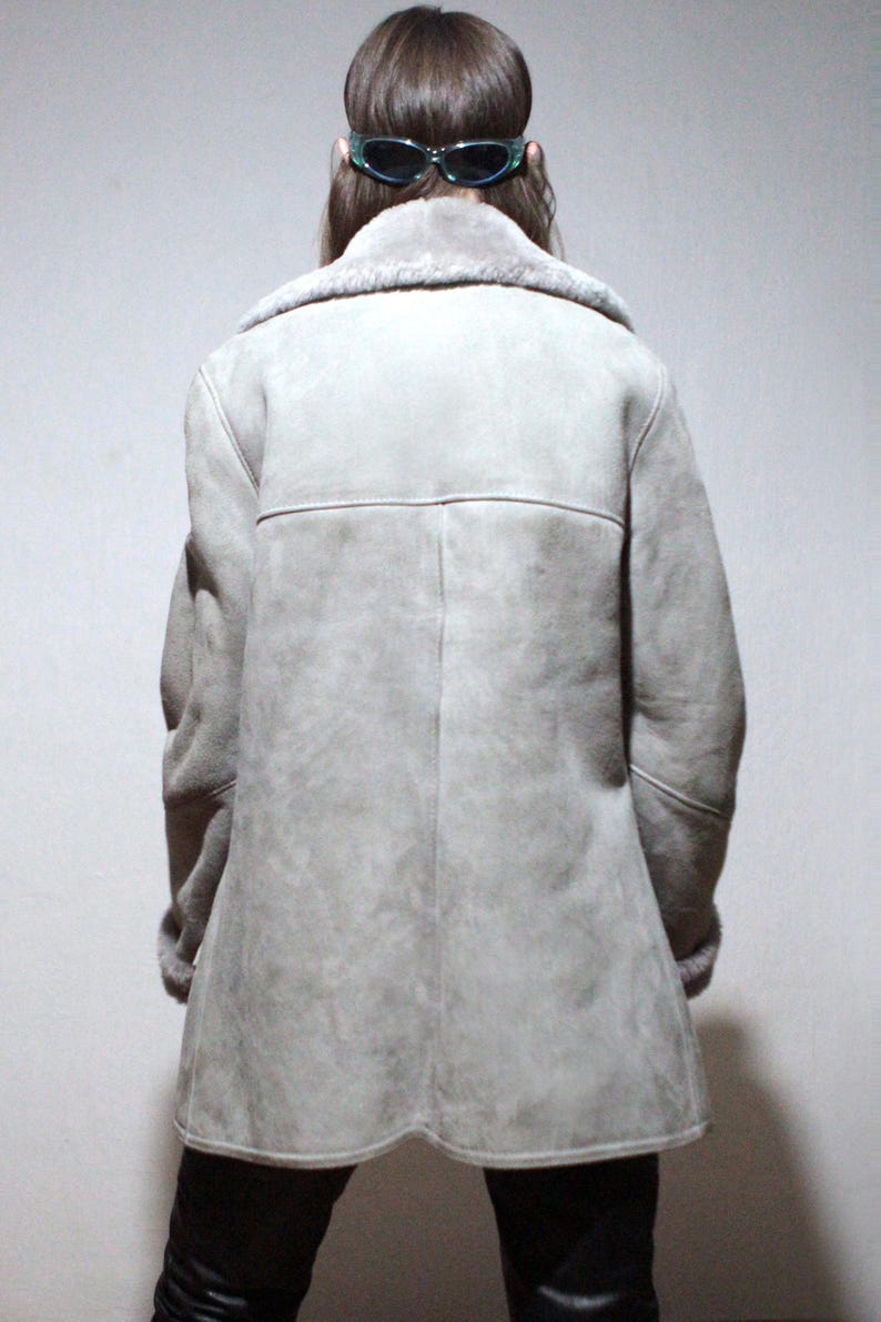 oversized sheepskin jacket with grey shearling interior and wooden buttons