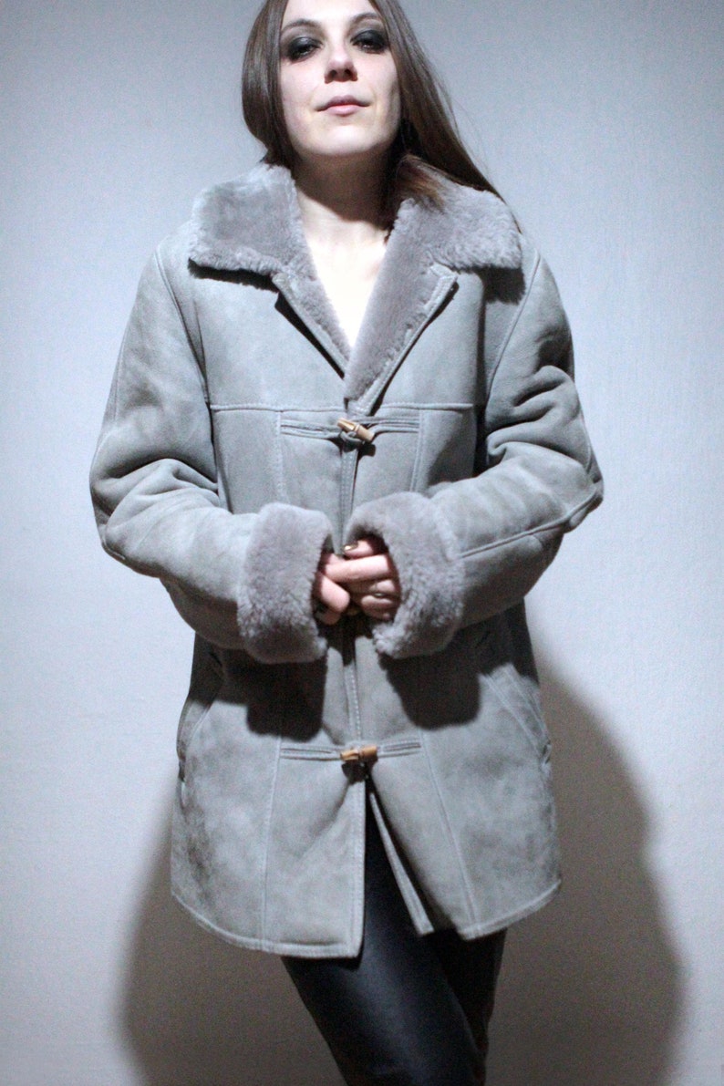 oversized sheepskin jacket with grey shearling interior and wooden buttons