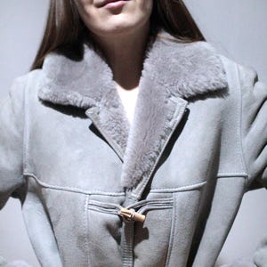 oversized sheepskin jacket with grey shearling interior and wooden buttons