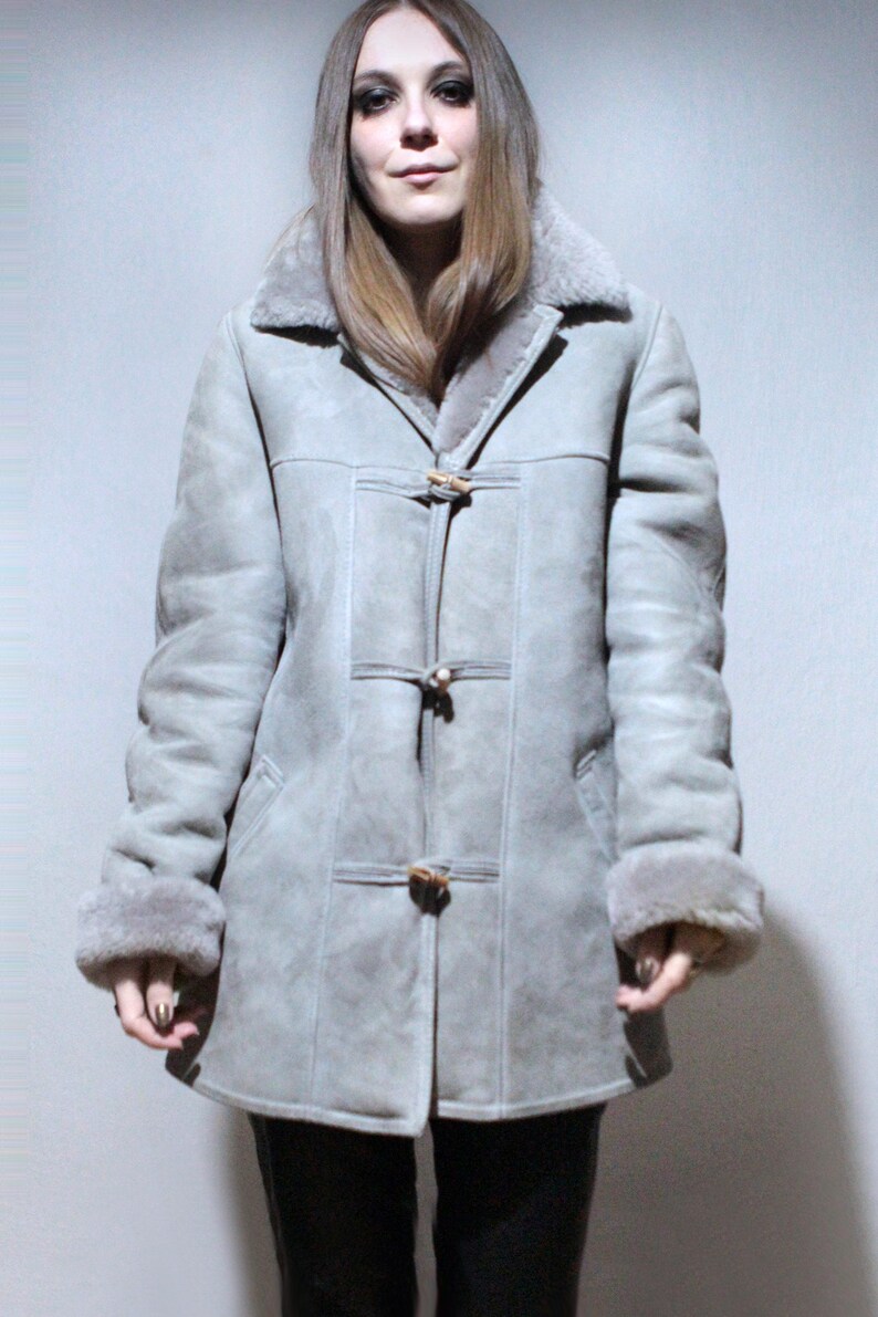 oversized sheepskin jacket with grey shearling interior and wooden buttons
