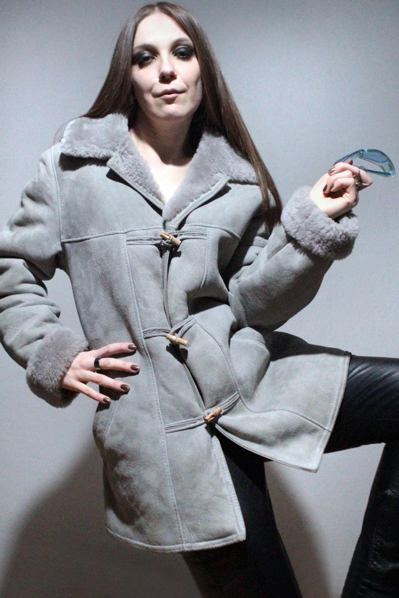 oversized sheepskin jacket with grey shearling interior and wooden buttons