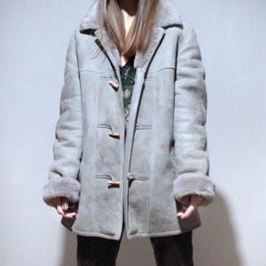 oversized sheepskin jacket with grey shearling interior and wooden buttons