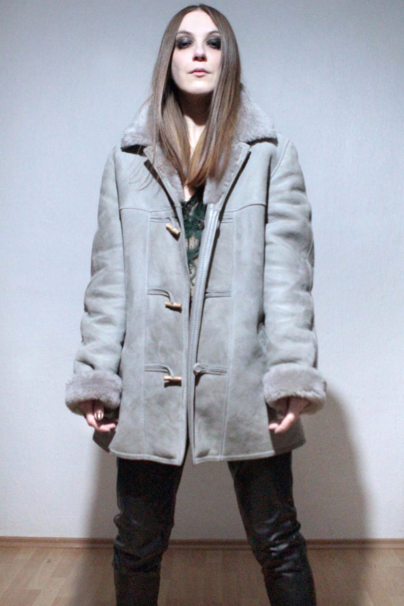 oversized sheepskin jacket with grey shearling interior and wooden buttons