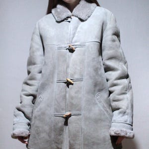 oversized sheepskin jacket with grey shearling interior and wooden buttons