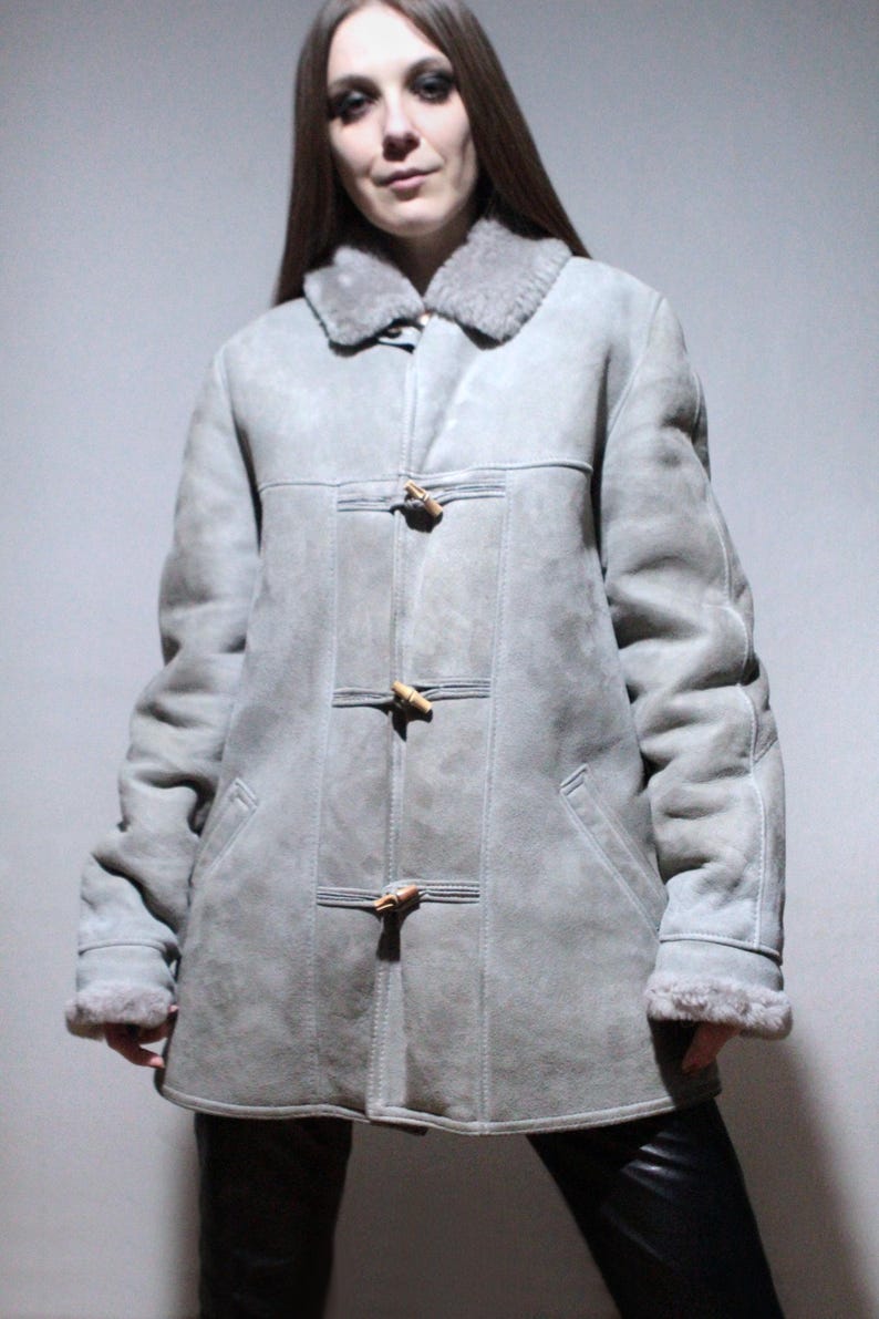 oversized sheepskin jacket with grey shearling interior and wooden buttons