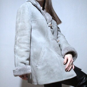 oversized sheepskin jacket with grey shearling interior and wooden buttons