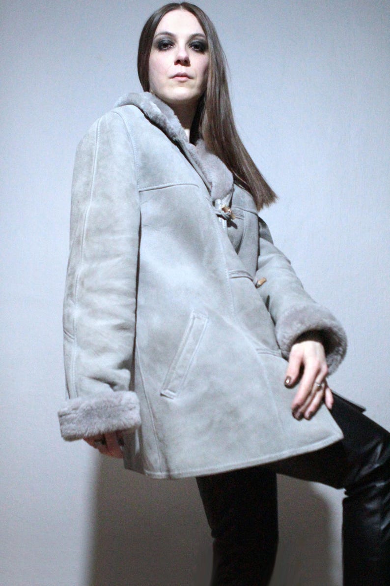 oversized sheepskin jacket with grey shearling interior and wooden buttons