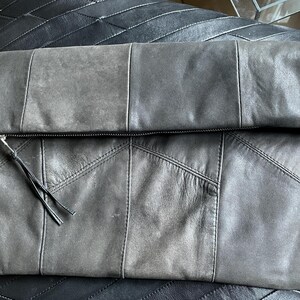 Large fold-over leather clutch bag with burgundy red interior