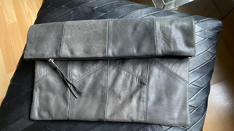 Large fold-over leather clutch bag with burgundy red interior